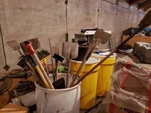 Barrel with Shovels, Scrapers and Brushes