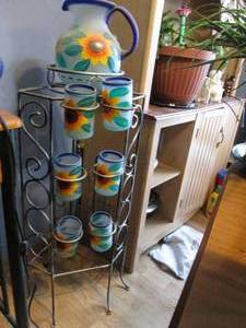 lot 357 image: Metal stand with a pitcher and flow...