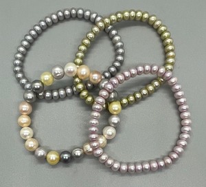 lot 115 image: Four Dyed Freshwater Pearl Stretch Bracelets