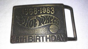 lot 251 image: Hotwheels 15th Anniversary Belt Buckle and NASCAR racer on card.