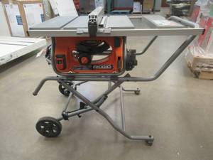 lot 330 image: RIDGID 15 Amp 10 in. Portable Pro Jobsite Table Saw with Stand (USED, IN DECENT CONDITION, WORKS)