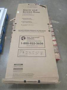 lot 434 image: EMCO 32 in. x 80 in. K900 Series White Vinyl Self-Storing Pet Storm Door (MISSING HARDWARE, PART OF THE HINGED PIECE IS DAMAGED, SEE PHOTOS)