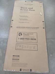 lot 438 image: EMCO 36 in. x 80 in. 100 Series White Self-Storing Storm Door