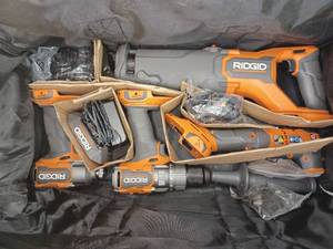 lot 10 image: RIDGID 18V Brushless Cordless 4-Tool Combo Kit with (1) 4.0 Ah and (1) 2.0 Ah MAX Output Batteries, 18V Charger, and Tool Bag