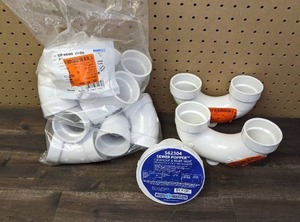 lot 154 image: Jones Stephens 3 in. x 4 in. PVC Sewer Popper Cleanout and Relief Valve, NIBCO 2 in. PVC DWV 45-Degree Hub x Hub Elbow Fitting (10-Pack), and (2) 2 in. PVC DWV Hub x P-Trap with Solvent Weld Joint and Cleanout