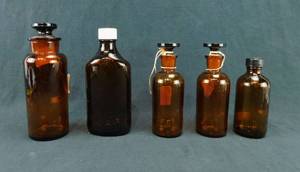 lot 57 image: Lot of 5 Assorted Amber Glass Bottles
