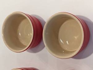 lot 36 image: Four Small Red Le Creuset Baking Cups