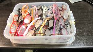 Bin of reading glasses of varying s...