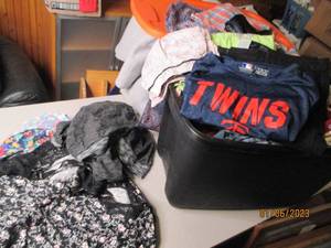 Covered tote filled with ladies clo...
