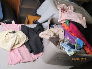 Covered tote of ladies clothing...
