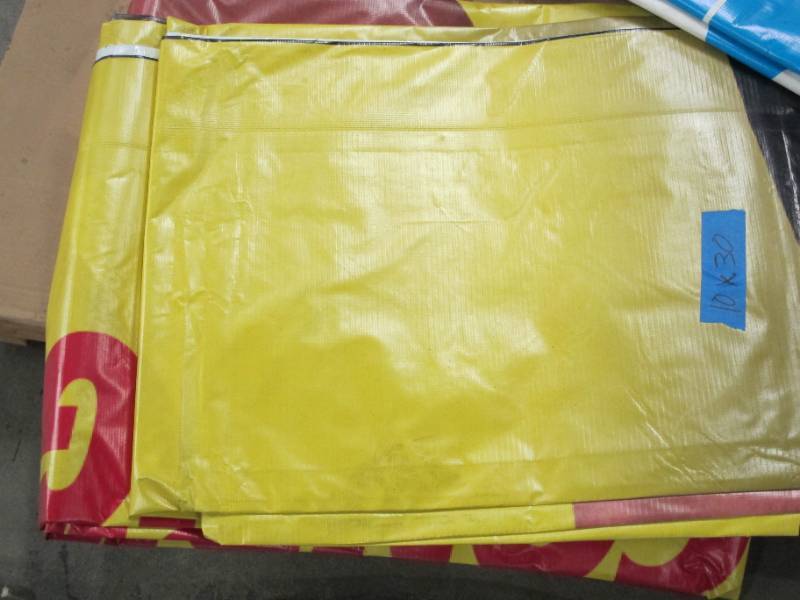 lot 131 image: 10 x 30 11 oz. Black Vinyl Tarp w Advertisement  Reused Billboard  13 mil Heavy Duty - A Grade
