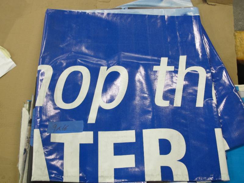 lot 132 image: 9 x 16 11 oz. Black Vinyl Tarp w Advertisement  Reused Billboard  13 mil Heavy Duty - A Grade