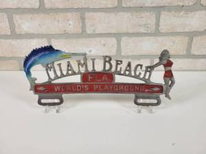 lot 63 image: Vintage Cast Aluminum License Plate Topper - Miami Beach, FL Worlds Playground