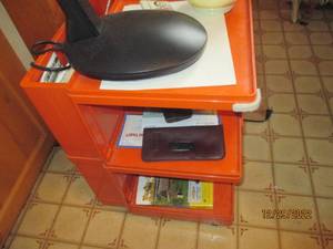 Orange desk on wheels with six stor...