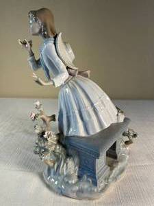 Lladro schoolgirl picking flowers sculpture