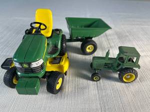 die cast John Deere toy lawn tractor with wagon  addtl. tractor  metal signage
