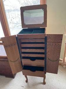 jewelry armoire with multiple drawers and mirror