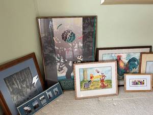 group of framed artwork and art mirror
