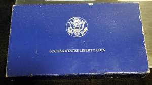 1986 US ELLIS ISLAND SILVER DOLLAR COMMEMORATIVE IN ORIGINAL PACKAGING