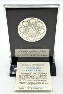lot 272 image: Franklin Mint Sterling Silver Holiday Medal The Miracle of Hanukkah