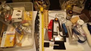lot 185 image: Paint Supplies, caulk gun, light bulbs in a tote.