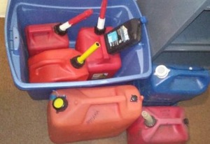 lot 223 image: gas cans (6) and  2 cycle oil.
