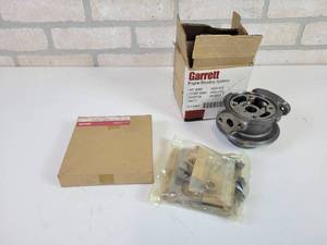 lot 128 image: NOS - GARRETT Bearing Housing (Part No. 448316-0035) and GARRETT Turbo Rebuild Kit (Part No. 472617-000)