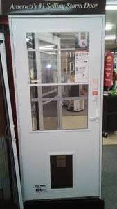 lot 72 image: Larson 36 in. Storm Door with pet Door.