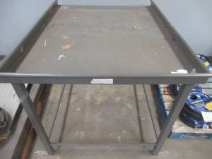STEEL TABLE - APPROXIMATELY 60 IN X 48 IN X 44 IN - USED IN WAREHOUSE