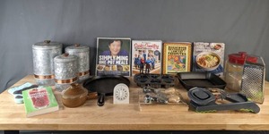 lot 149 image: Collection of Kitchen Items Cookbooks, Galvanized Metal Canisters, Cast Iron Fry Pan & Muffin Tin, Box Grater, Timer and More B