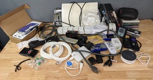 lot 188 image: Pile of Amazon Echo Dot, Socket Sense Multi-Extension Cord, P2P IP Camera, Thermometer, Remote Controls, Cords, DVDs, CDs, Etc. B