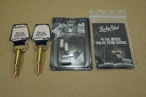 lot 51 image: 2 Lucky Shot Bullet Keychains with 2 Packs 40 Cal Valve Stem Covers