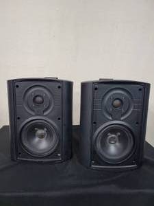 lot 17 image: A pair of Niles OS-10 IndoorOutdoor Speakers (Black) W Mounting Brackets