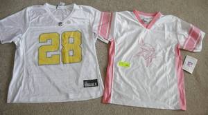 lot 134 image: 2 Girls Viking shirts both Large, but the Pink one says 1012, the yellow one is a good 1-2 inches wider