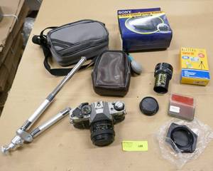 lot 148 image: Camera lot - Canon AE1, bags, tripods