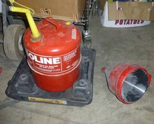 lot 234 image: 5 gallon metal gas can with stand to put it in when hauling in your vehicle and 3 funnels
