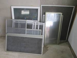 lot 23 image: Assorted window screens and a new d...