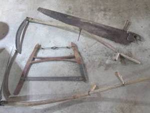 lot 29 image: 2 Sythes a buck saw and a long saw...