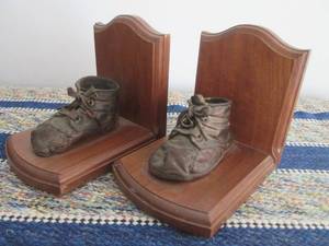 lot 90 image: lBookends with very old baby shoes...