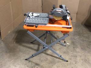 lot 31 image: RIDGID 9 Amp Corded 7 in. Wet Tile Saw with Stand, Customer returns, Review all pictures