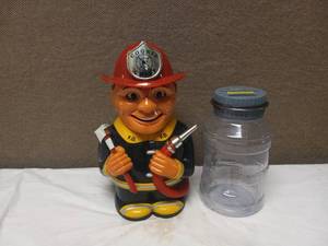 lot 16 image: FIREMAN COOKIE JAR & BANK WITH CHANGE COUNTER