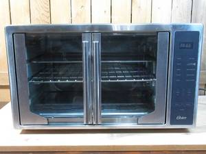 lot 26 image: Oster Air Fryer Oven, 10-in-1 Countertop Toaster Oven, XL Fits 2 16 Pizzas, Stainless Steel French Doors