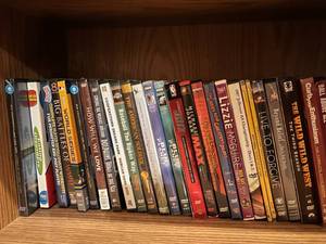 lot 28 image: Wooden Book Shelf with Movies, Nacho Libra, Annie, Monty Python, and Many More Located in Basement