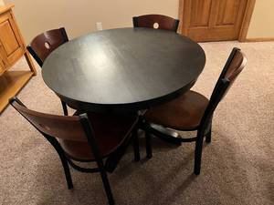 lot 115 image: Black Round Table with 4 Chairs Located in Basement