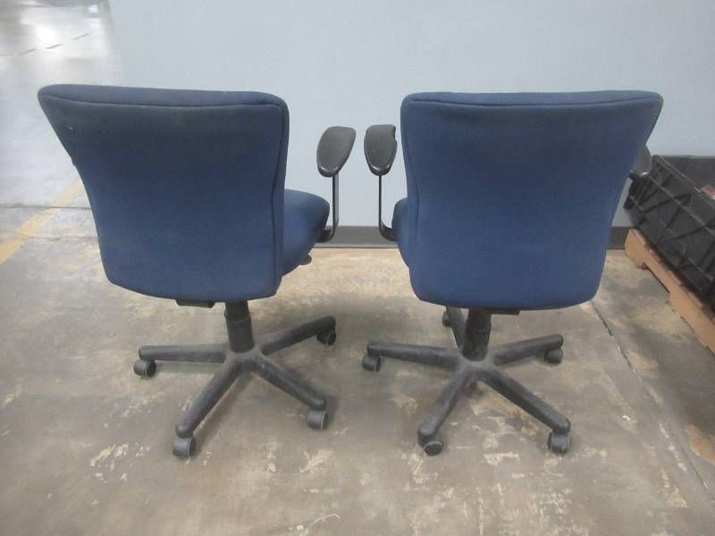 lot 64 image: (2) Office Chairs on casters with adjustable Height - Some Staining on Upholstery, Slight Damage to arm rests, Used in Warehouse, SOLD AS IS.