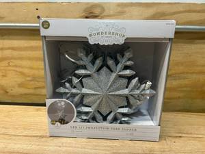 lot 91 image: WONDERSHOP 10in 4 LED Glitter Snowflake LED Projection Tree Topper- Silver