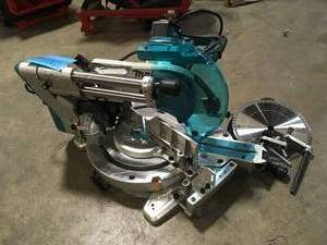 lot 22 image: Makita  12 in. Dual-Bevel Sliding Compound Miter Saw with Laser with bonus Compact Folding Miter Saw Stand, Customer return, Review all pictures