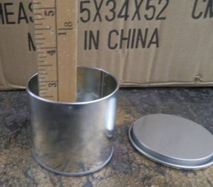 lot 44 image: NEW CASE OF ILLUME TIN CANS WITH LIDS.
