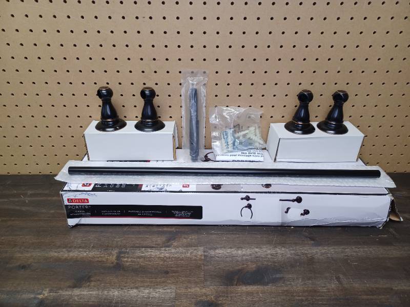 lot 115 image: Set of Delta Porter Collection 24 in. Towel Bar and a Toilet Paper Holder in Oil Rubbed Bronze