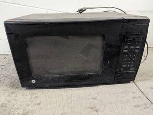 lot 7 image: GE microwave, inside needs a new co...